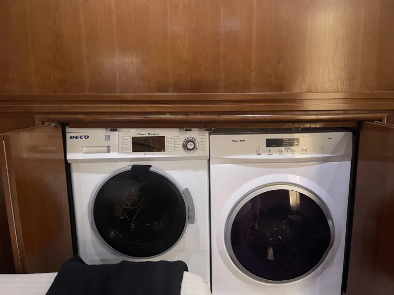 Slide: The Image of Laundry appliances in a 1999 Carver 530 Voyager Pilothouse, wooden cabinetry background. - 28