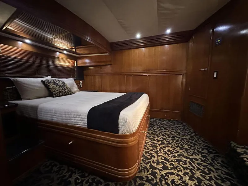 Slide: The Image of Luxurious bedroom interior of 1999 Carver 530 Voyager Pilothouse yacht with elegant wood finish. - 3
