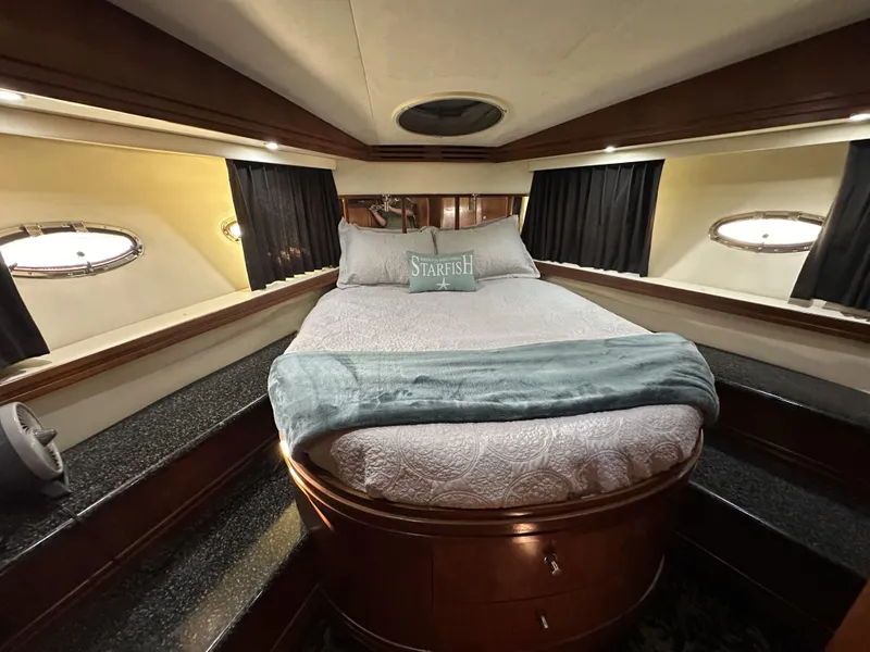 Slide: The Image of Luxurious bedroom in 1999 Carver 530 Voyager Pilothouse yacht with elegant bedding. - 30