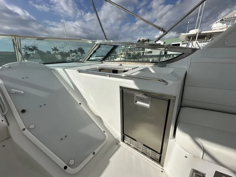 Slide: The Image of 1999 Carver 530 Voyager Pilothouse yacht interior with seating and storage under a cloudy sky. - 34