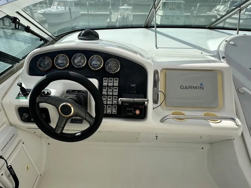 Slide: The Image of 1999 Carver 530 Voyager Pilothouse helm with Garmin navigation system and control panel. - 36