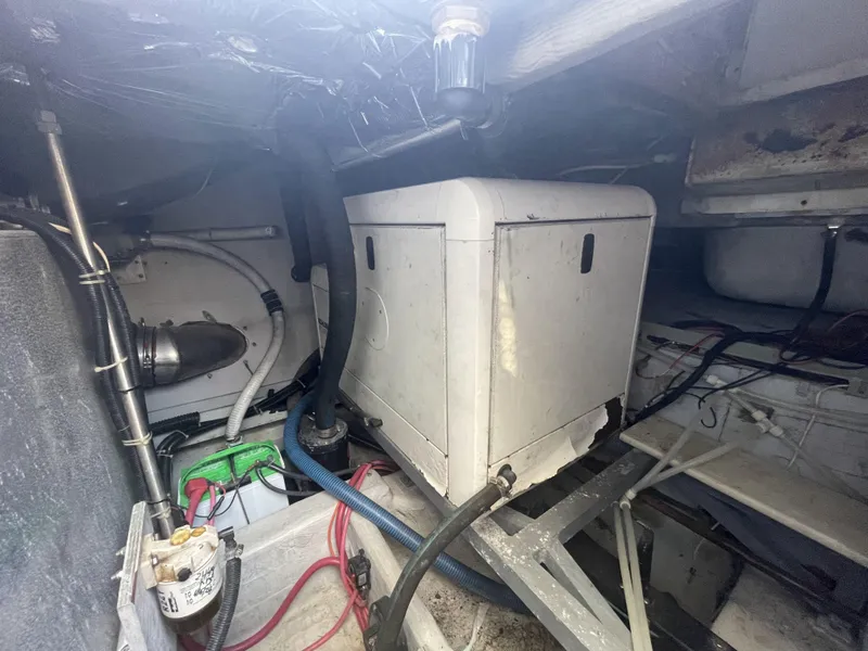 Slide: The Image of Engine room of 1999 Carver 530 Voyager Pilothouse with visible machinery and wiring. - 41