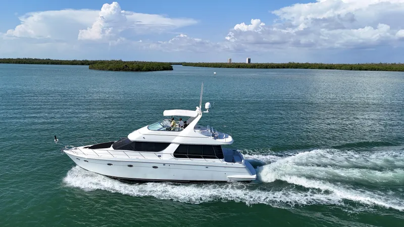 Slide: The Image of 1999 Carver 530 Voyager Pilothouse cruising on open water under a clear sky. - 8