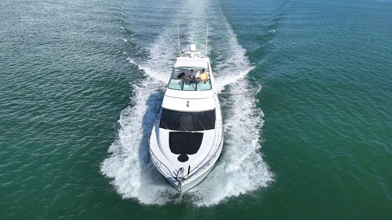 Slide: The Image of 1999 Carver 530 Voyager Pilothouse cruising on open water, aerial view. - 9