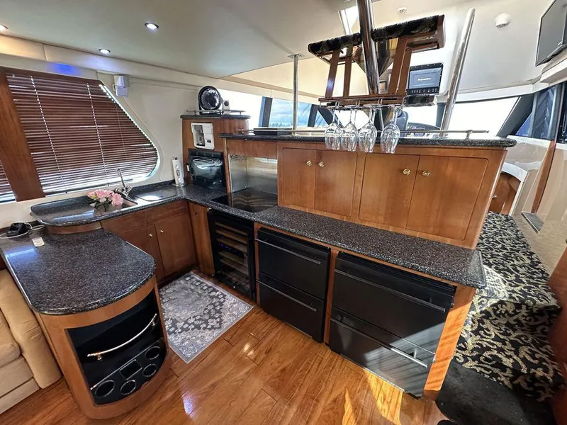 Slide: The Image of Luxurious interior of a 1999 Carver 530 Voyager Pilothouse yacht with modern kitchen amenities. - 12