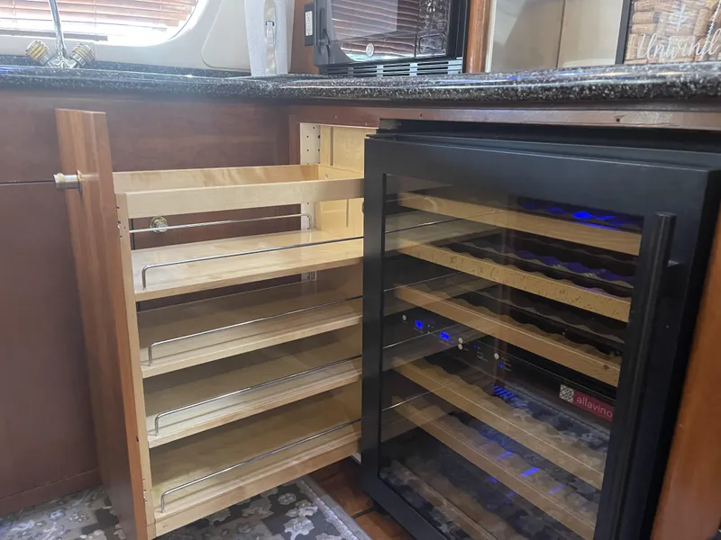 Slide: The Image of 1999 Carver 530 Voyager Pilothouse kitchen with wine cooler and pull-out shelves. - 15