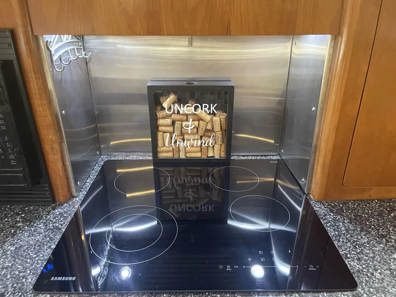 Slide: The Image of Modern kitchen in 1999 Carver 530 Voyager Pilothouse with Samsung cooktop and wine-themed decor. - 16