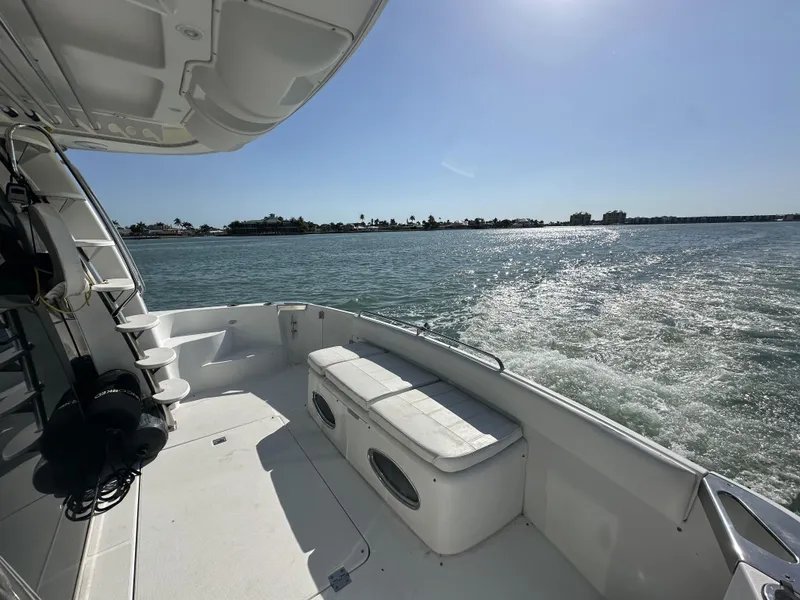 Slide: The Image of 1999 Carver 530 Voyager Pilothouse cruising on sunny waters, spacious deck view. - 17