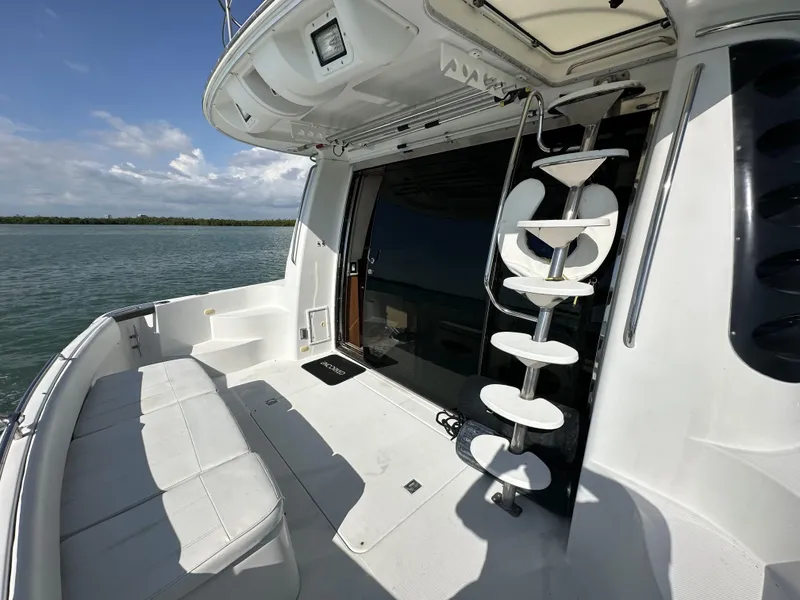 Slide: The Image of 1999 Carver 530 Voyager Pilothouse yacht deck with seating and spiral staircase. - 18