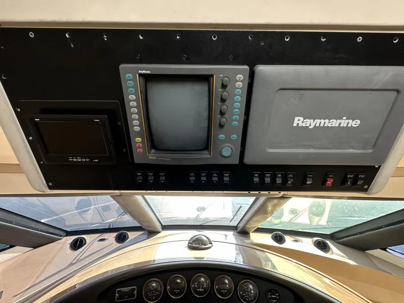 Slide: The Image of 1999 Carver 530 Voyager Pilothouse dashboard with Raymarine navigation equipment. - 21