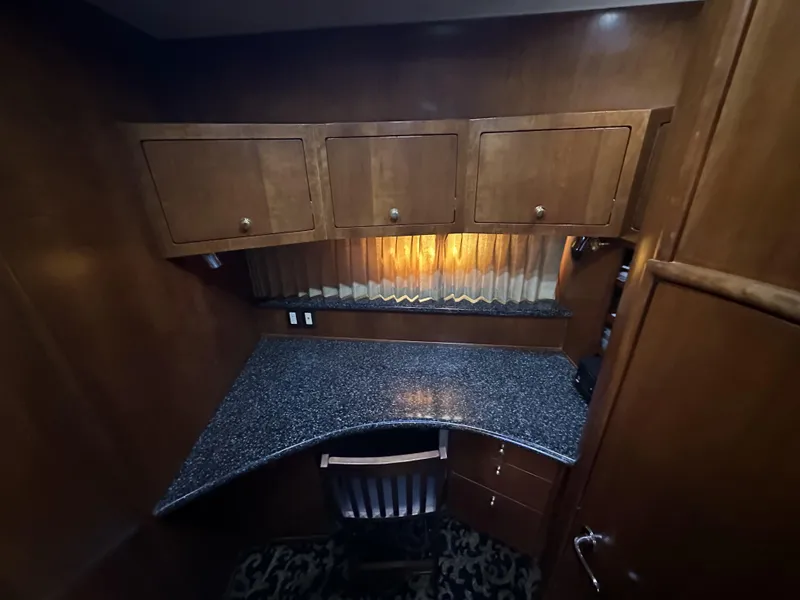 Slide: The Image of 1999 Carver 530 Voyager Pilothouse interior with wooden cabinets and granite countertop. - 29