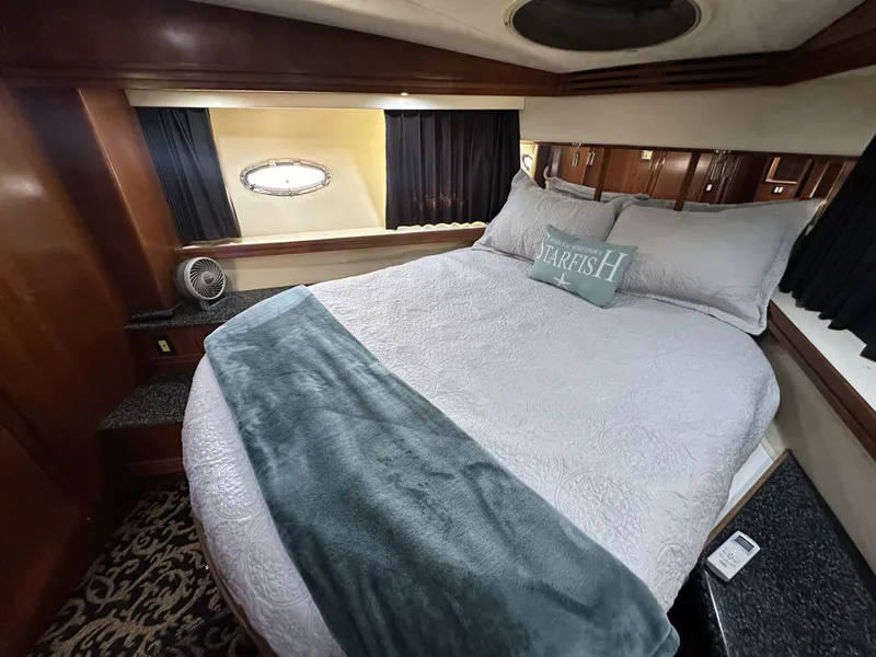 Slide: The Image of Luxurious bedroom in 1999 Carver 530 Voyager Pilothouse yacht with cozy bedding and elegant decor. - 31
