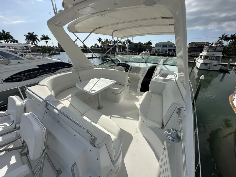 Slide: The Image of 1999 Carver 530 Voyager Pilothouse yacht with spacious deck and seating area in marina. - 33