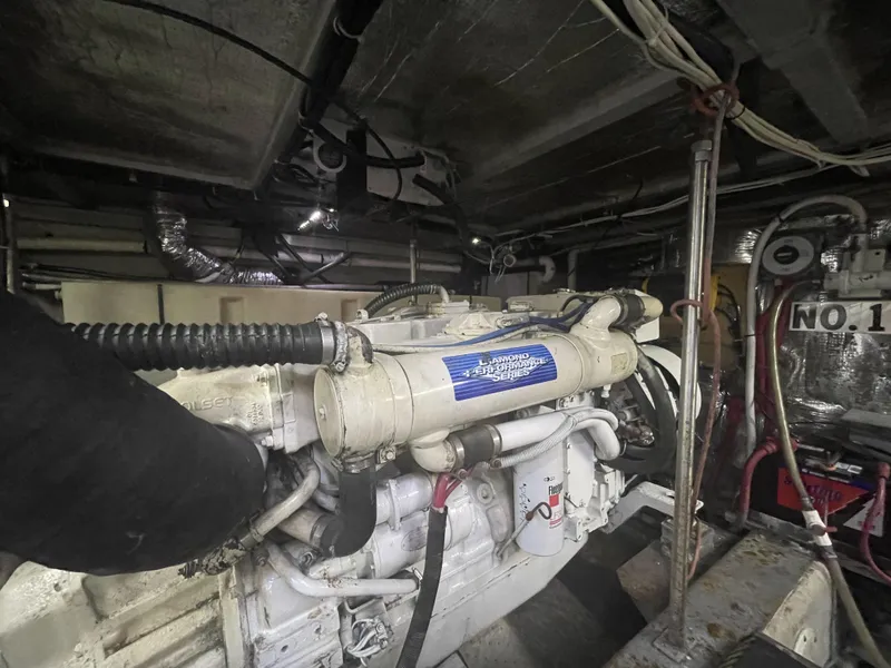 Slide: The Image of Engine room of 1999 Carver 530 Voyager Pilothouse with visible machinery and wiring. - 43