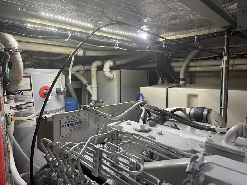 Slide: The Image of Engine room of 1999 Carver 530 Voyager Pilothouse with visible machinery and piping. - 46