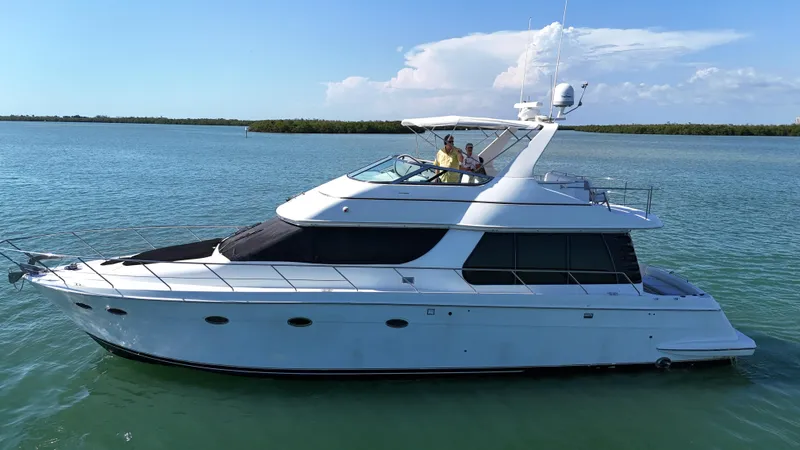 Slide: The Image of 1999 Carver 530 Voyager Pilothouse yacht cruising on calm waters. - 5