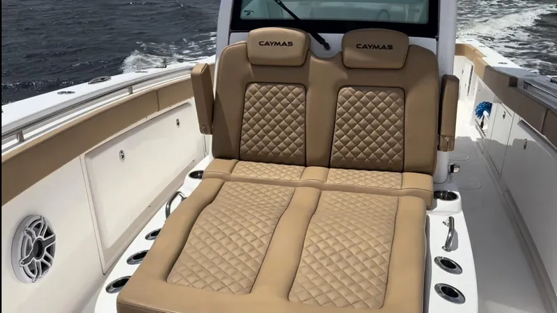 Slide: The Image of 2023 Caymas 341 CC boat with luxurious tan quilted seating on deck. - 14