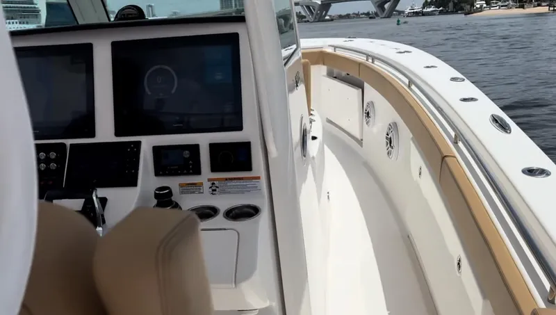 Slide: The Image of 2023 Caymas 341 CC boat interior with modern dashboard and waterfront view. - 18
