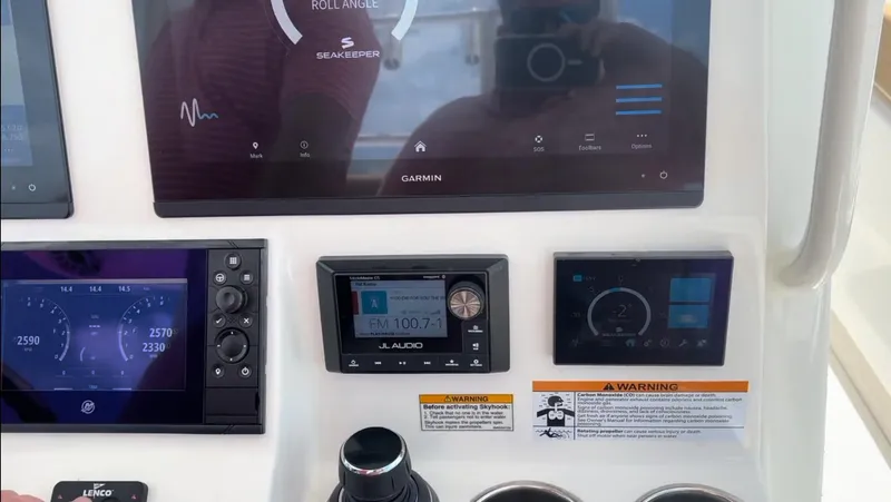 Slide: The Image of Control panel of 2023 Caymas 341 CC boat with Garmin and JL Audio displays. - 24