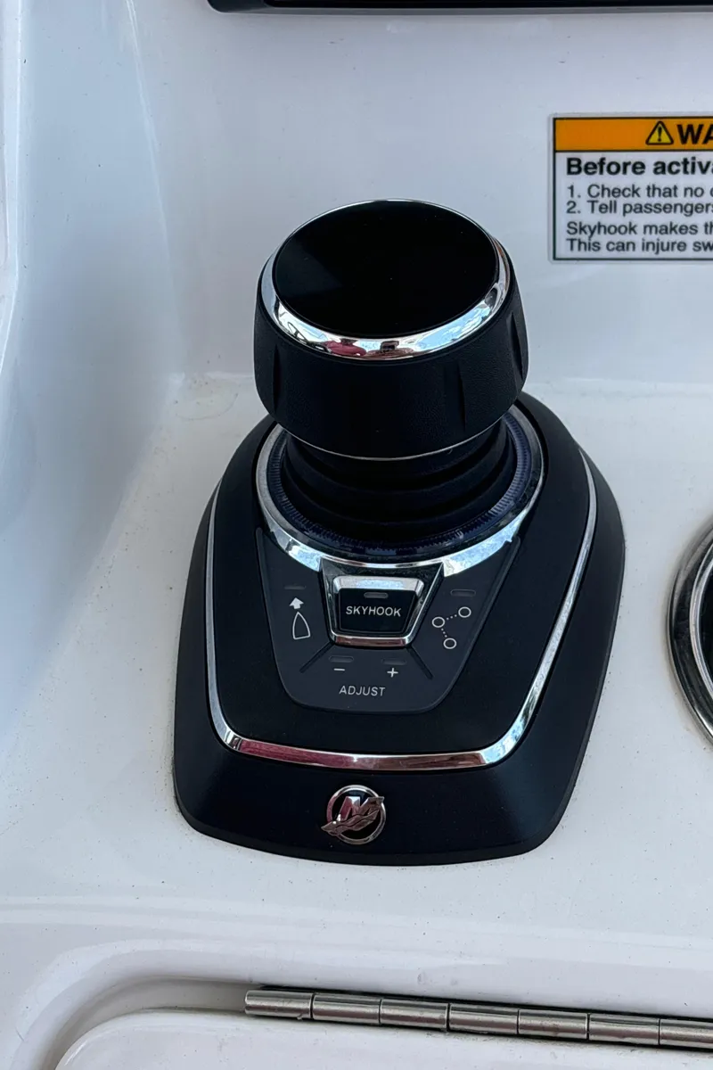 Slide: The Image of 2023 Caymas 341 CC boat control panel with joystick and warning label. - 26