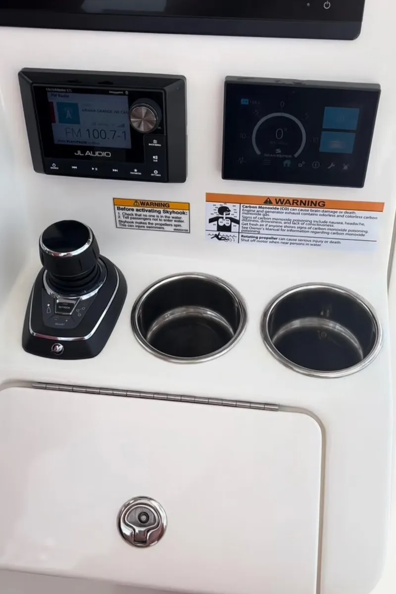 Slide: The Image of 2023 Caymas 341 CC dashboard with controls, displays, and cup holders. - 27