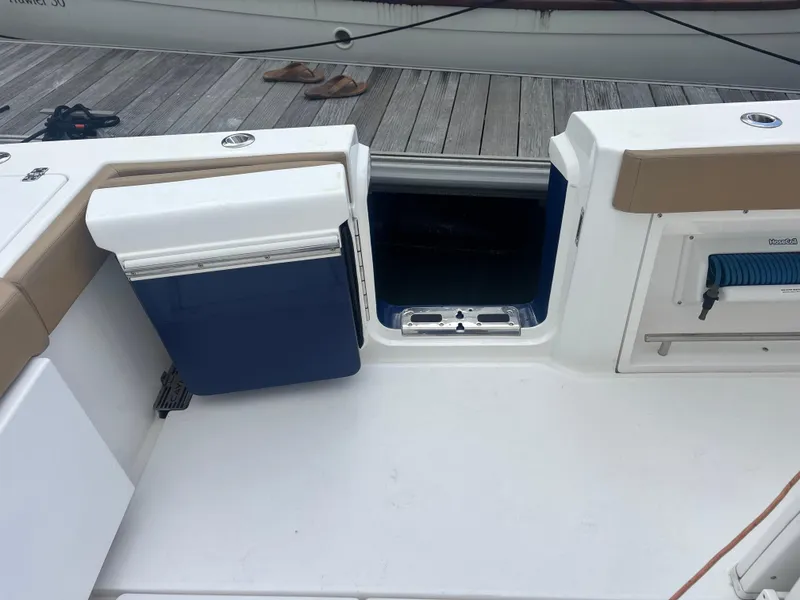 Slide: The Image of 2023 Caymas 341 CC boat deck with storage compartments and seating. - 33