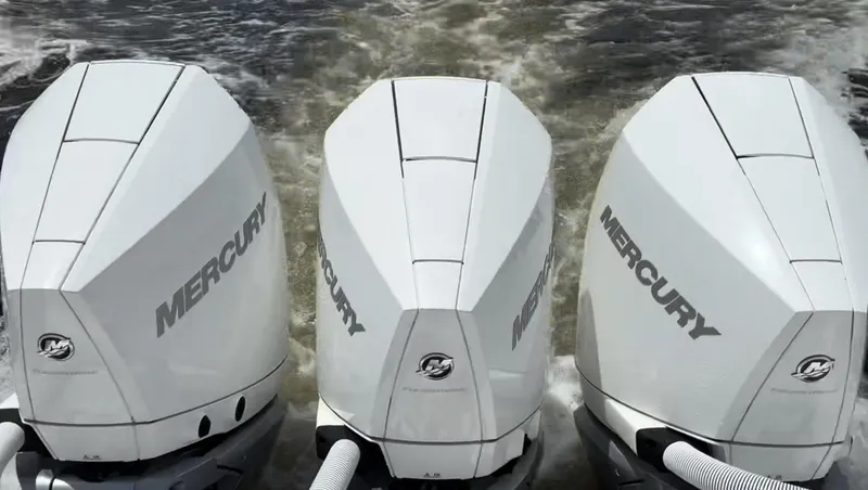 Slide: The Image of Triple Mercury outboard engines on 2023 Caymas 341 CC boat in action. - 38