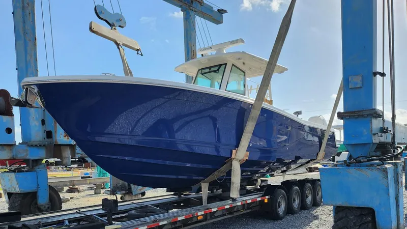 Slide: The Image of 2023 Caymas 341 CC boat in blue, on a trailer, ready for transport. - 5