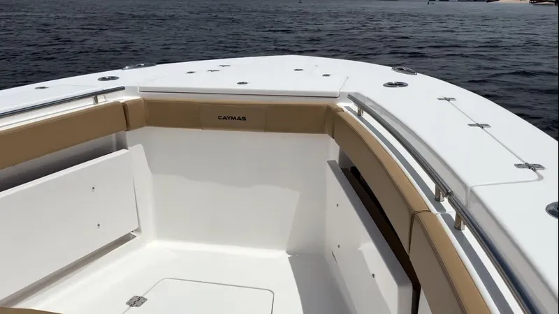 Slide: The Image of 2023 Caymas 341 CC boat, spacious deck with tan seating, on calm water. - 7