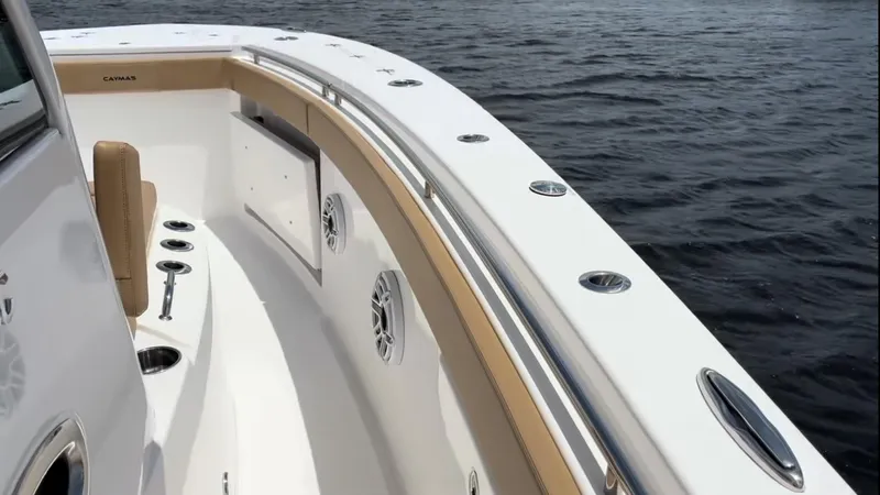 Slide: The Image of 2023 Caymas 341 CC boat deck with sleek design on calm water. - 8