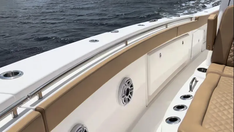 Slide: The Image of 2023 Caymas 341 CC boat interior with tan seating and ocean view. - 9