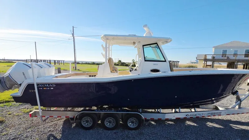 Slide: The Image of 2023 Caymas 341 CC boat on trailer, side view, outdoors, sunny day. - 39
