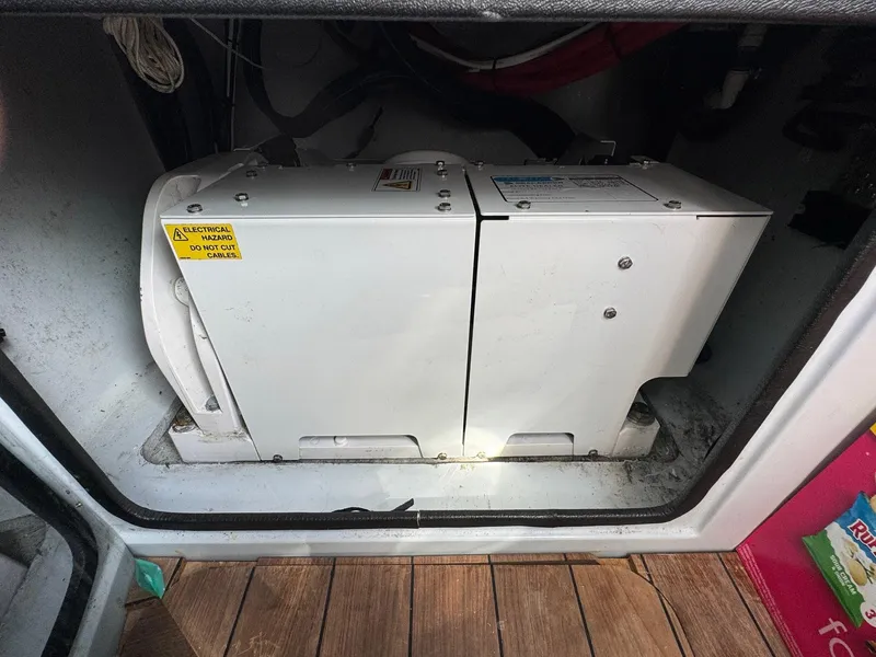 Slide: The Image of 2022 Contender 44 ST boat generator compartment with wooden flooring. - 12