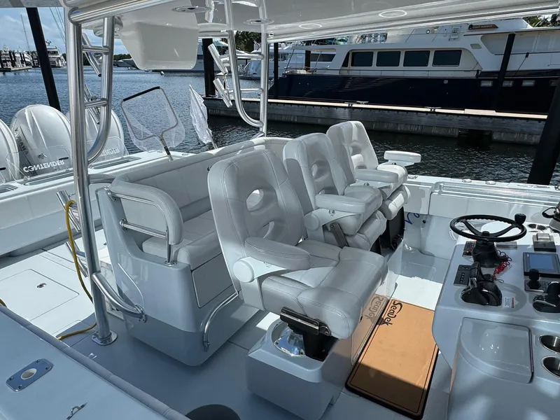 Slide: The Image of 2022 Contender 44 ST boat interior with white seating and control panel. - 14