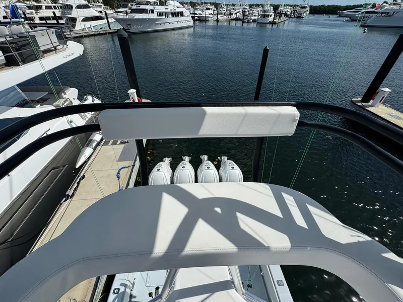 Slide: The Image of 2022 Contender 44 ST boat docked at marina with multiple outboard engines. - 18