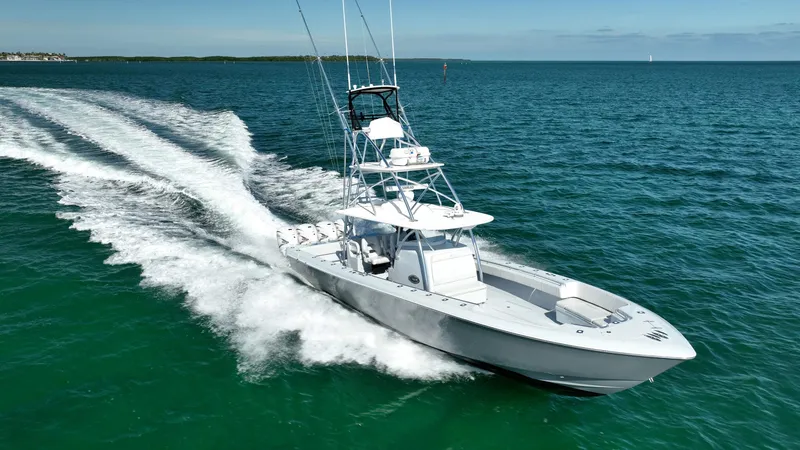 Slide: The Image of 2022 Contender 44 ST boat cruising on open water, creating a dynamic wake. - 2