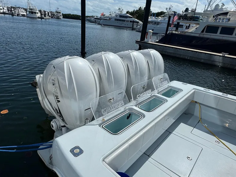Slide: The Image of 2022 Contender 44 ST boat with four Yamaha outboard engines docked at marina. - 25