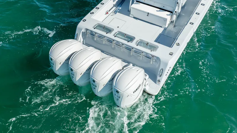 Slide: The Image of 2022 Contender 44 ST boat with four powerful outboard engines on turquoise water. - 27