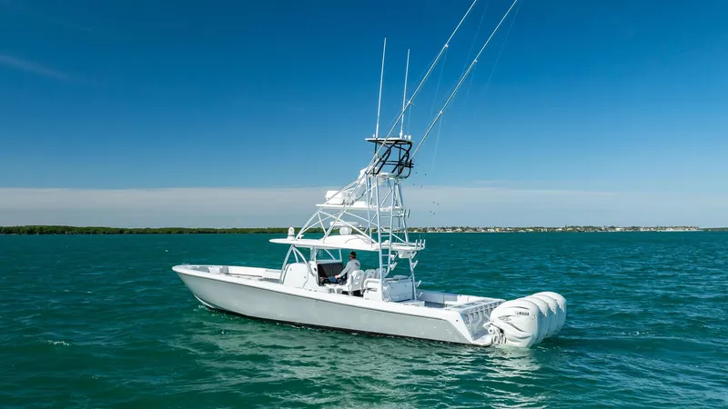 Slide: The Image of 2022 Contender 44 ST boat on open water under clear blue sky. - 28