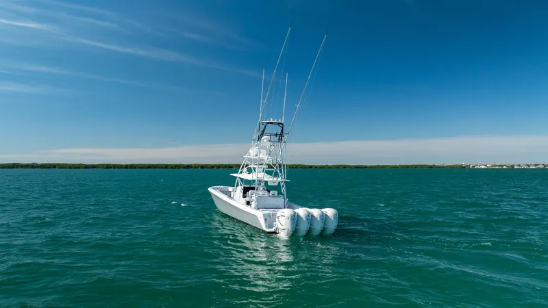 Slide: The Image of 2022 Contender 44 ST boat on open water under clear blue sky. - 29