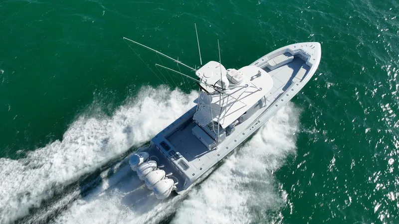 Slide: The Image of Aerial view of 2022 Contender 44 ST boat speeding on open water. - 32