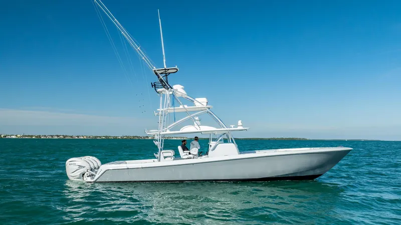 Slide: The Image of 2022 Contender 44 ST boat cruising on open water under clear blue sky. - 33