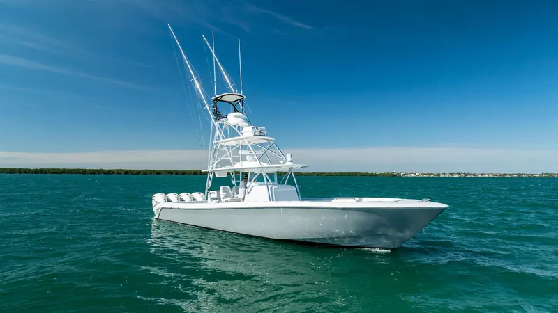 Slide: The Image of 2022 Contender 44 ST boat on open water under clear blue sky. - 34