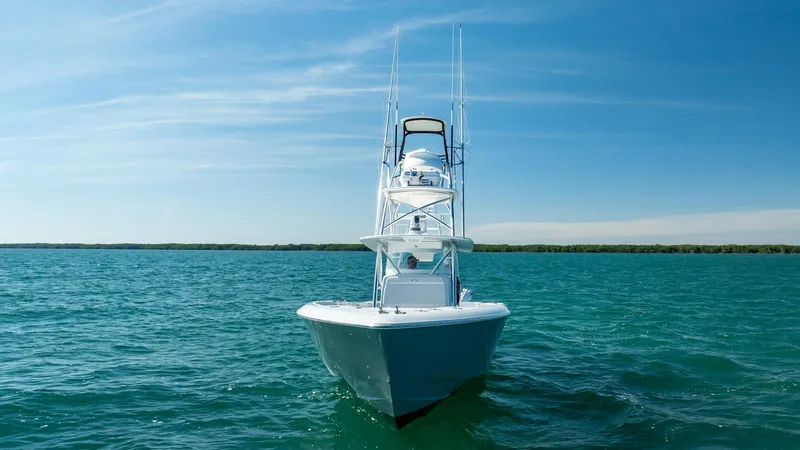 Slide: The Image of 2022 Contender 44 ST boat on open water under clear blue sky. - 35