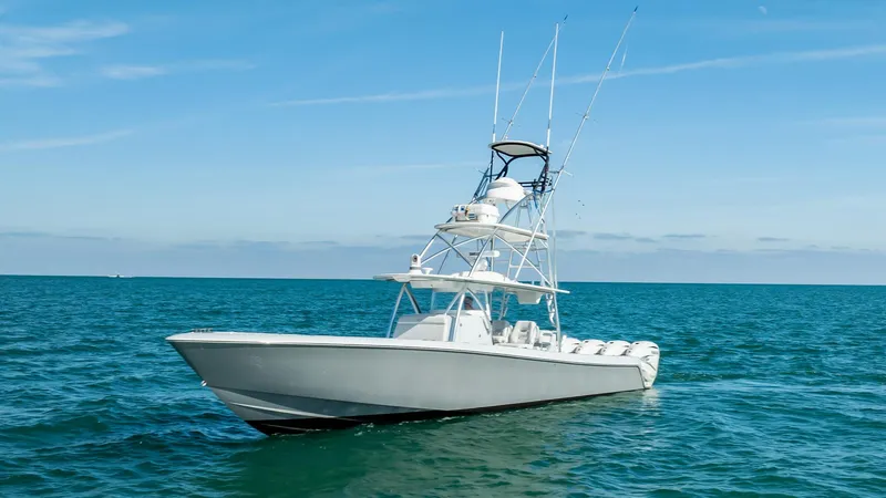 Slide: The Image of 2022 Contender 44 ST boat on open sea under clear blue sky. - 36