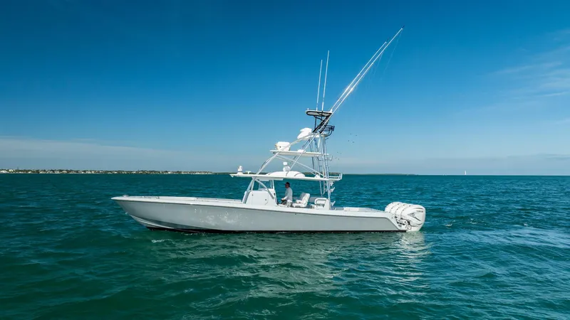 Slide: The Image of 2022 Contender 44 ST boat cruising on open water under clear blue skies. - 37