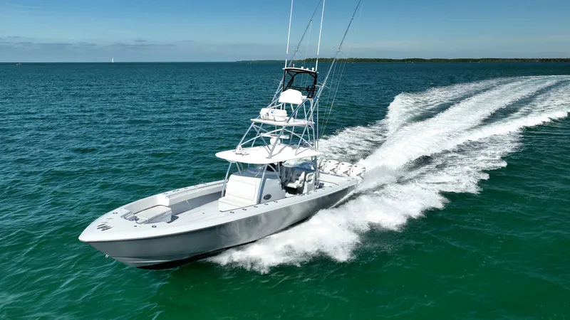 Slide: The Image of 2022 Contender 44 ST boat cruising on open water, creating a dynamic wake. - 4