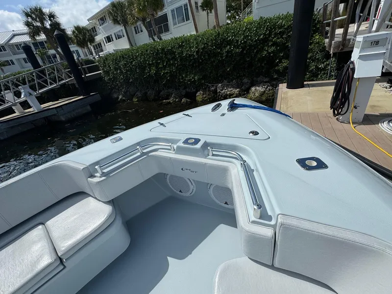 Slide: The Image of 2022 Contender 44 ST boat docked, featuring sleek seating and modern design. - 7