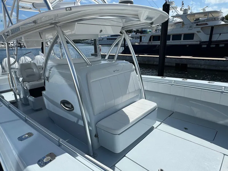 Slide: The Image of 2022 Contender 44 ST boat interior with seating and helm, docked at marina. - 9
