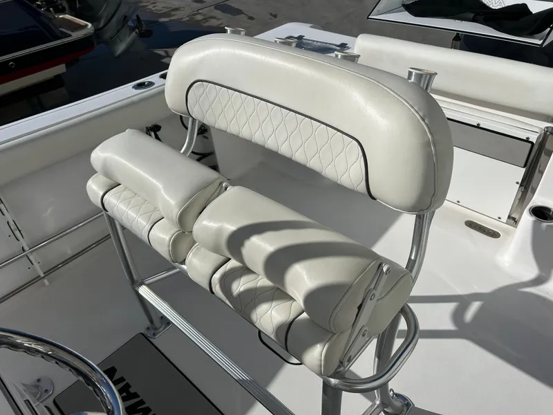 Slide: The Image of 2020 Sportsman Open 232 Center Console boat seat with white cushioned upholstery. - 10